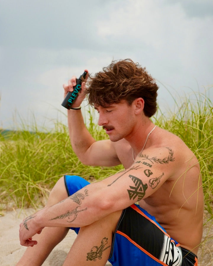 Sitting in the dune grass, spraying it into dry hair